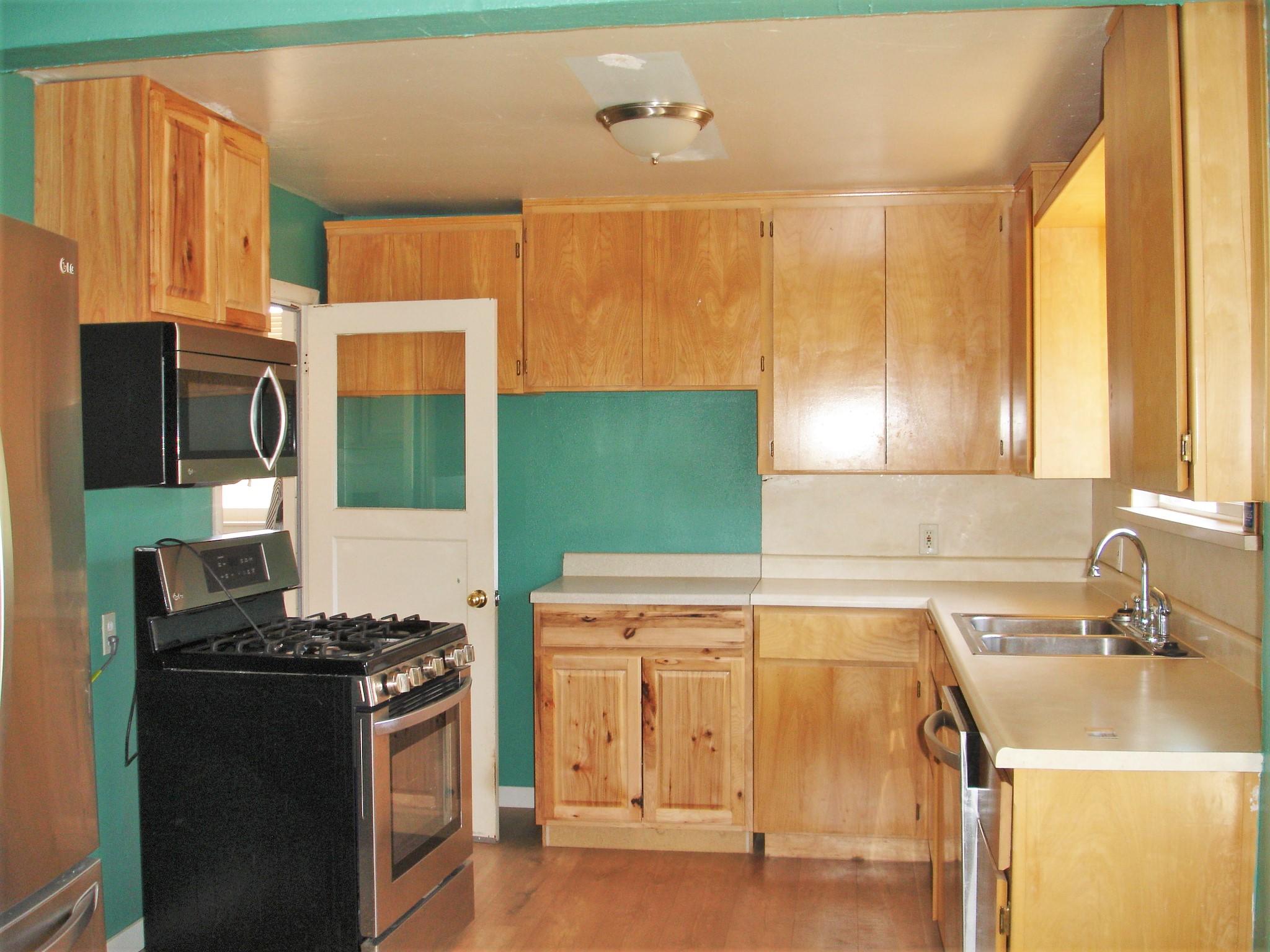 1146 Echo Road Redding, CA 96002 - Photo 7 of 36 a kitchen with a sink stove and refrigerator