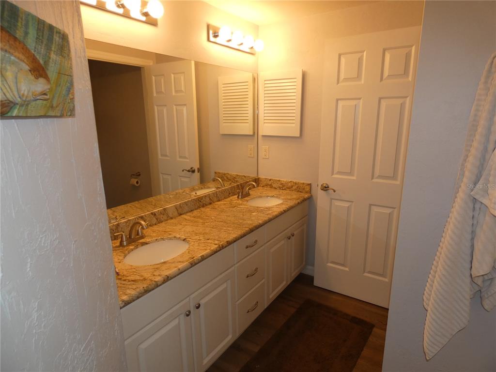 502 Main Street, Unit 106 Horseshoe Beach, FL 32648 - Photo 15 of 27 a bathroom with a granite countertop sink and a mirror