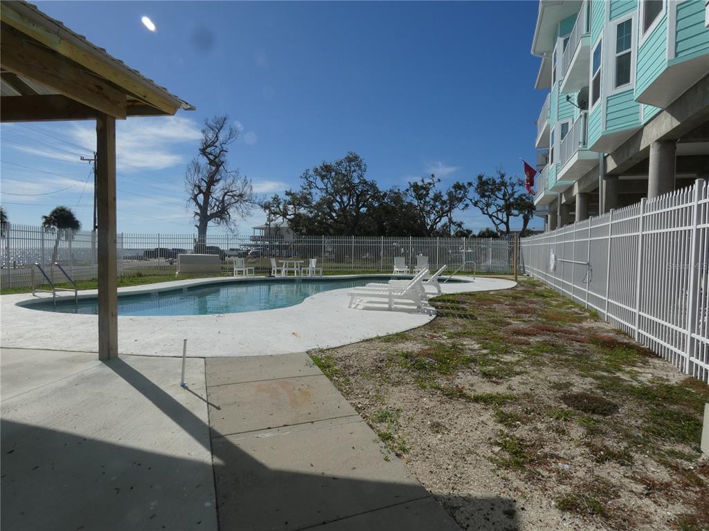 502 Main Street, Unit 106 Horseshoe Beach, FL 32648 - Photo 24 of 27 a view of a swimming pool with an outdoor seating