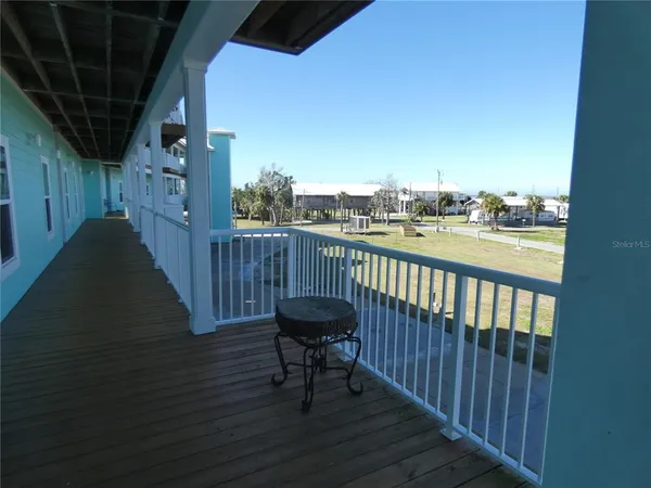 a view of a balcony with furniture