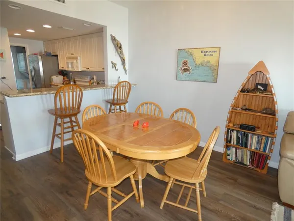 a dining room with furniture and wooden floor