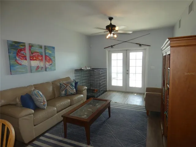 a living room with furniture and a ceiling fan