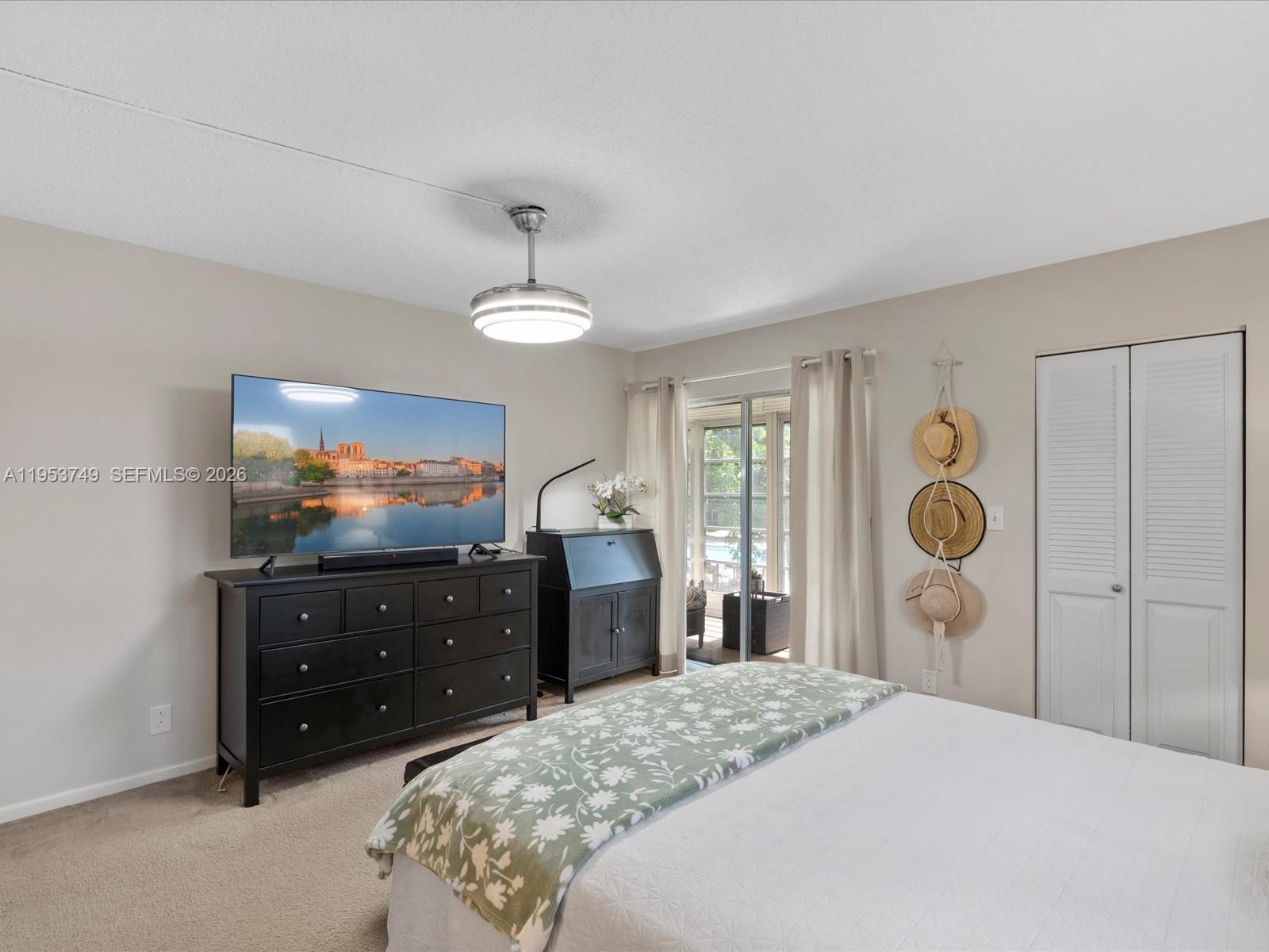 2004 Granada Drive, Unit O2 Coconut Creek, FL 33066 - Photo 12 of 26 a bedroom with a bed and a television