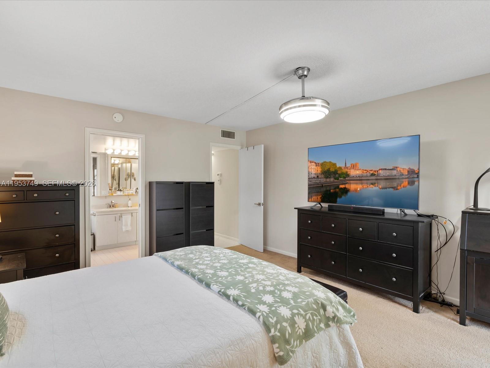 2004 Granada Drive, Unit O2 Coconut Creek, FL 33066 - Photo 13 of 26 a bedroom with a bed and a dresser