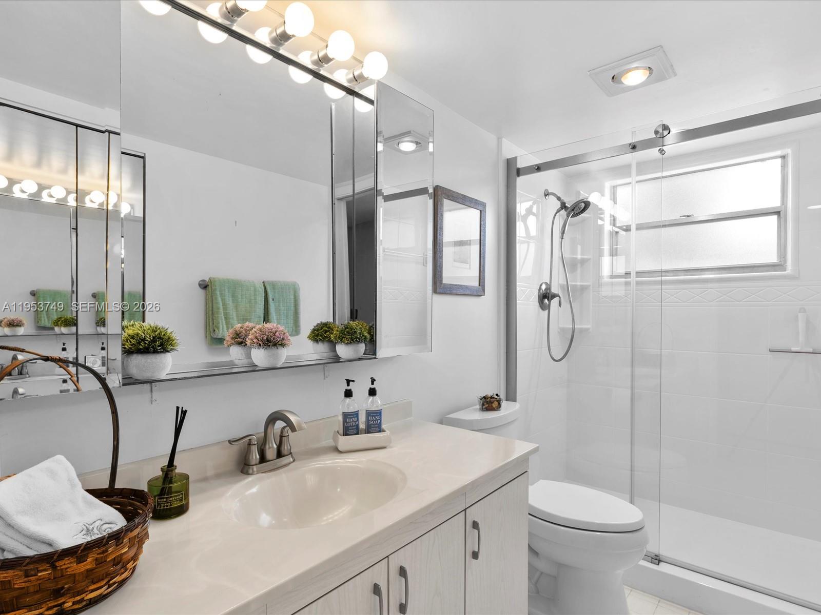 2004 Granada Drive, Unit O2 Coconut Creek, FL 33066 - Photo 16 of 26 a bathroom with a sink toilet double vanity and shower