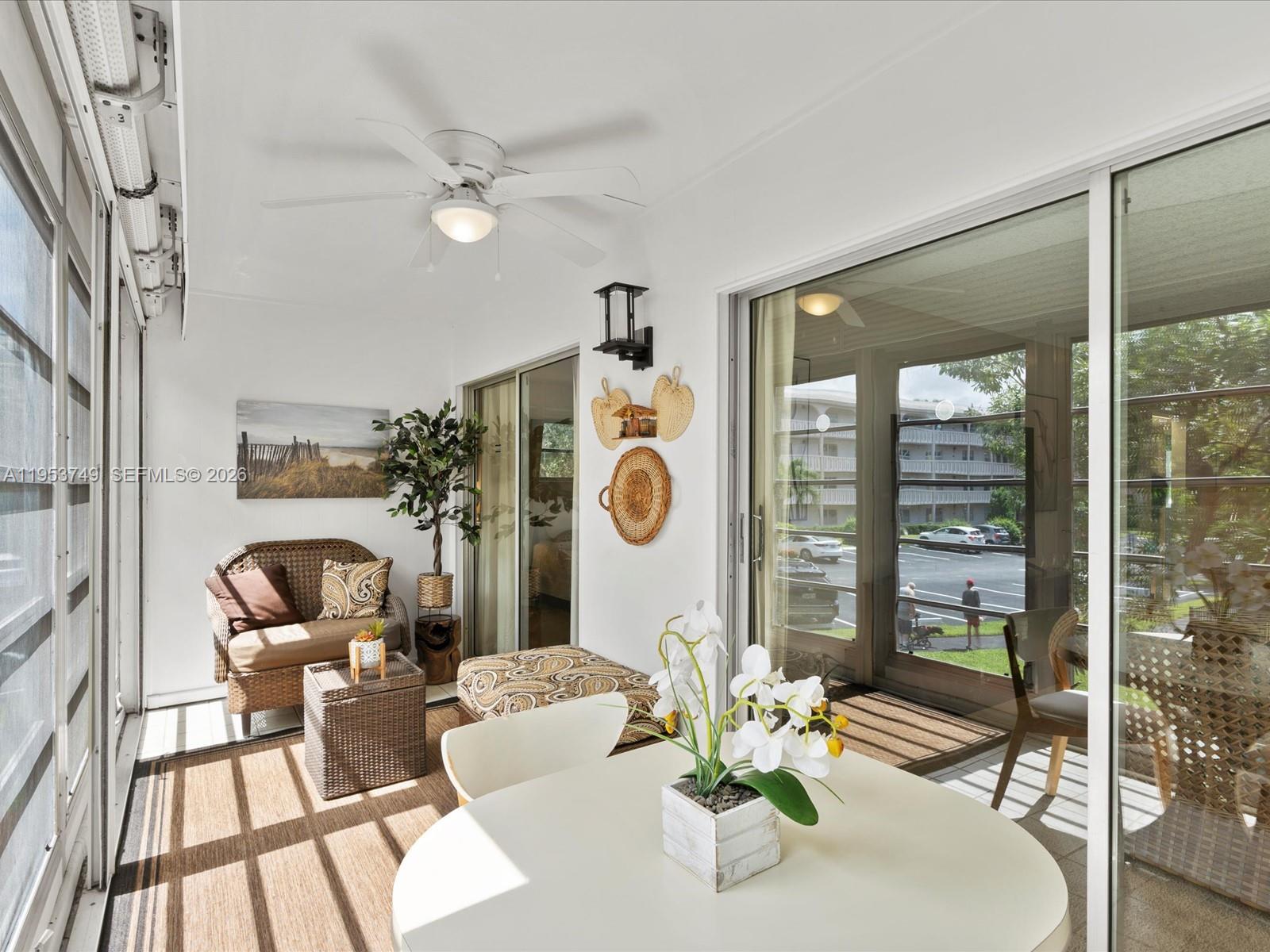 2004 Granada Drive, Unit O2 Coconut Creek, FL 33066 - Photo 18 of 26 a living room with furniture and a floor to ceiling window