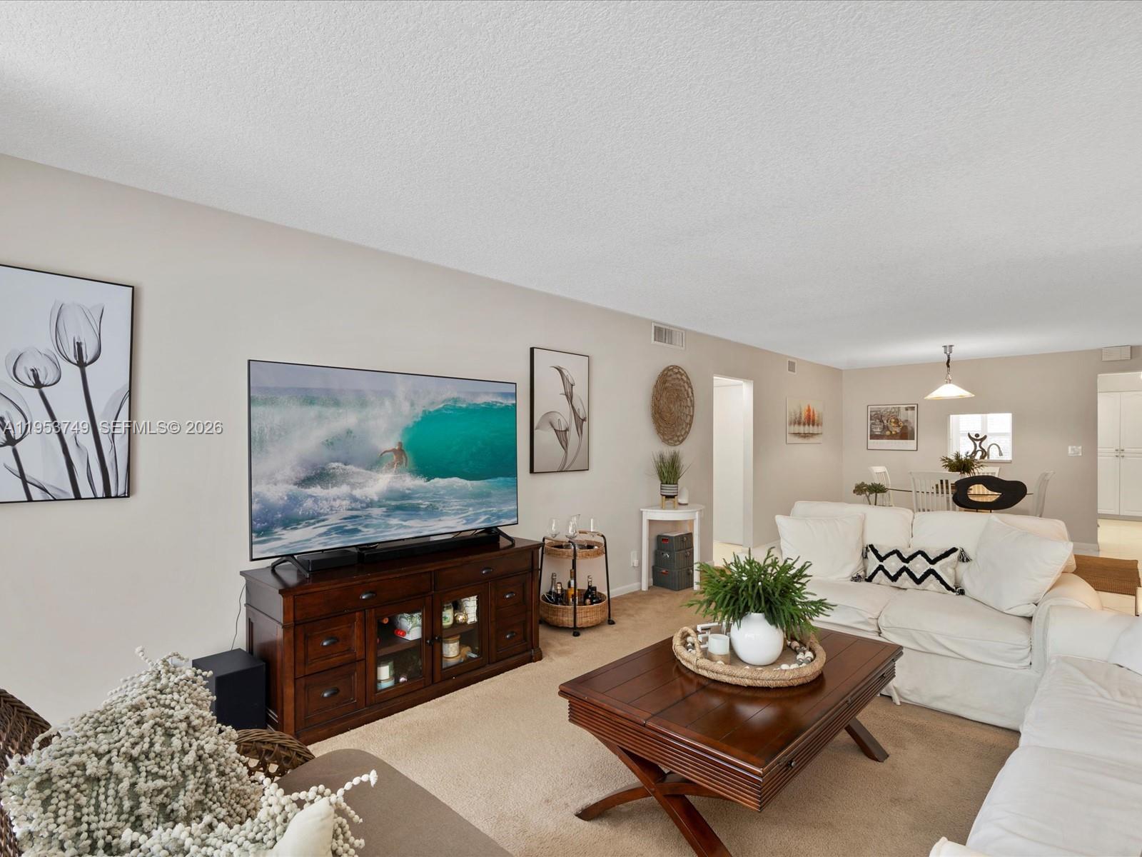 2004 Granada Drive, Unit O2 Coconut Creek, FL 33066 - Photo 2 of 26 a living room with furniture and a fireplace