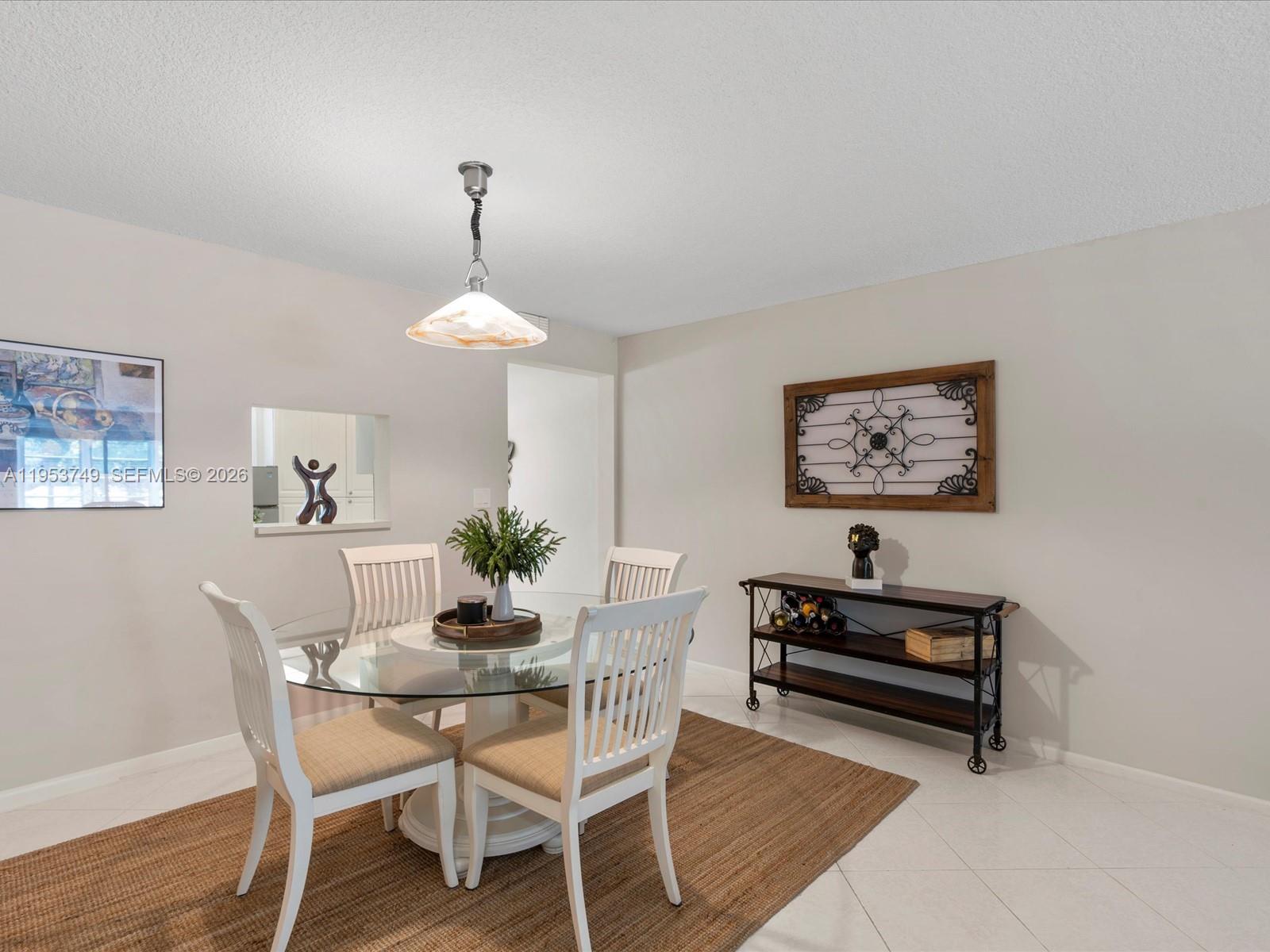 2004 Granada Drive, Unit O2 Coconut Creek, FL 33066 - Photo 5 of 26 a dining room with furniture and window