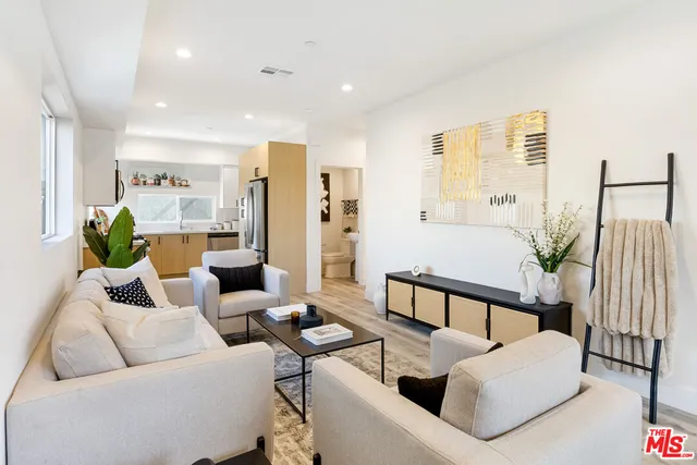 a living room with furniture and a potted plant
