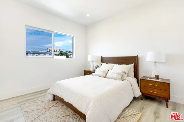 a bedroom with a bed and a night stand