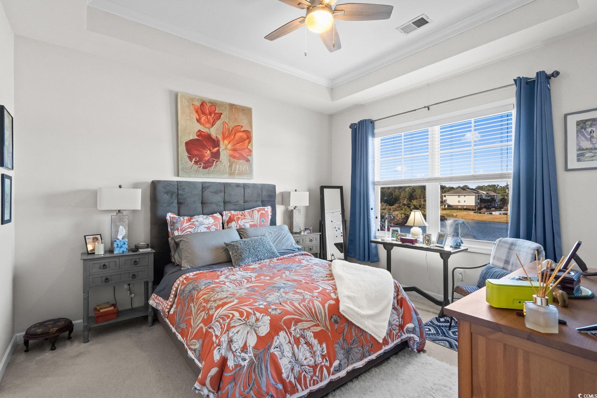 336 Kiskadee Loop, Unit 19O Conway, SC 29526 - Photo 13 of 26 Bedroom featuring a raised ceiling, carpet flooring, ornamental molding, and a ceiling fan