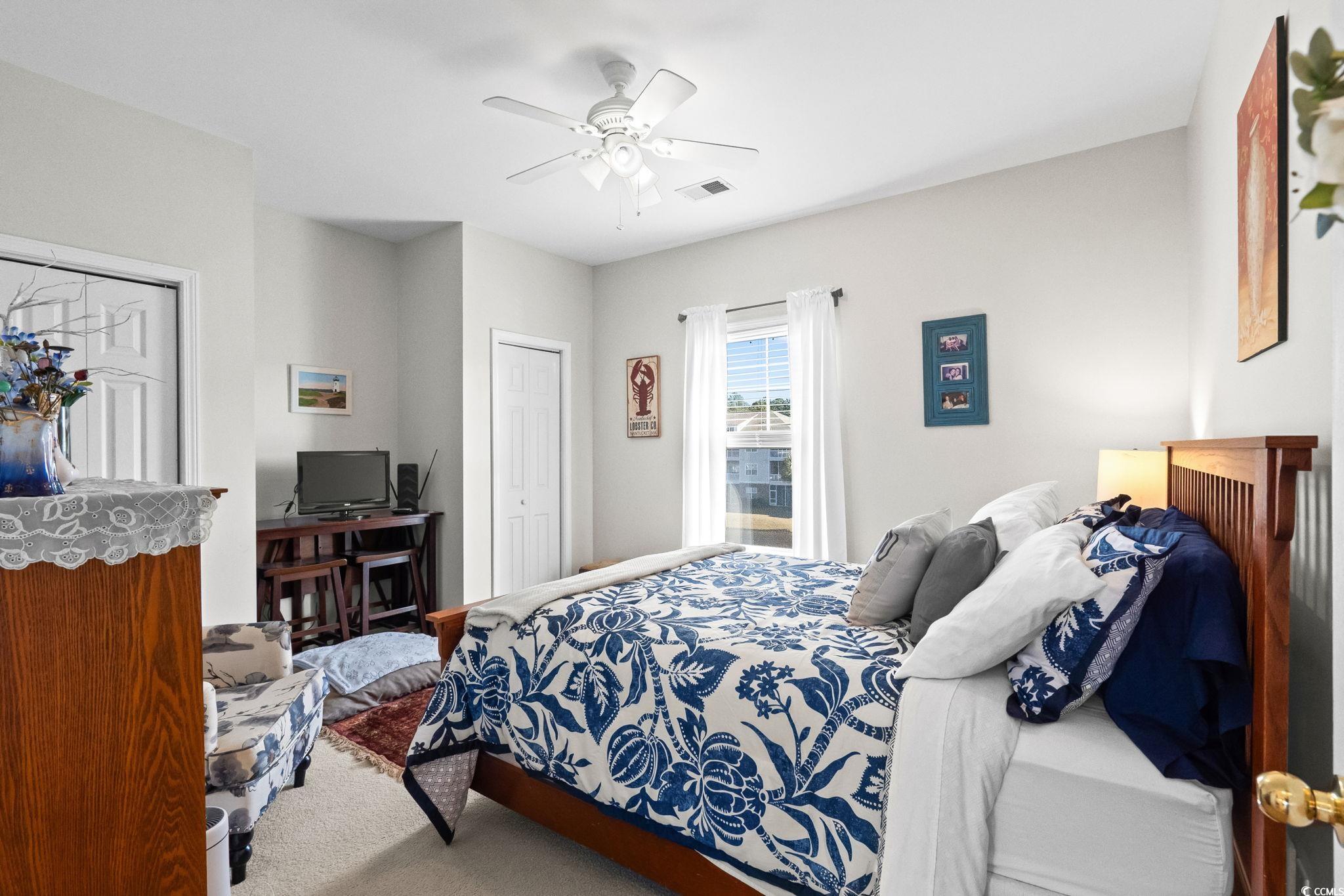 336 Kiskadee Loop, Unit 19O Conway, SC 29526 - Photo 14 of 20 Carpeted bedroom featuring ceiling fan and two closets