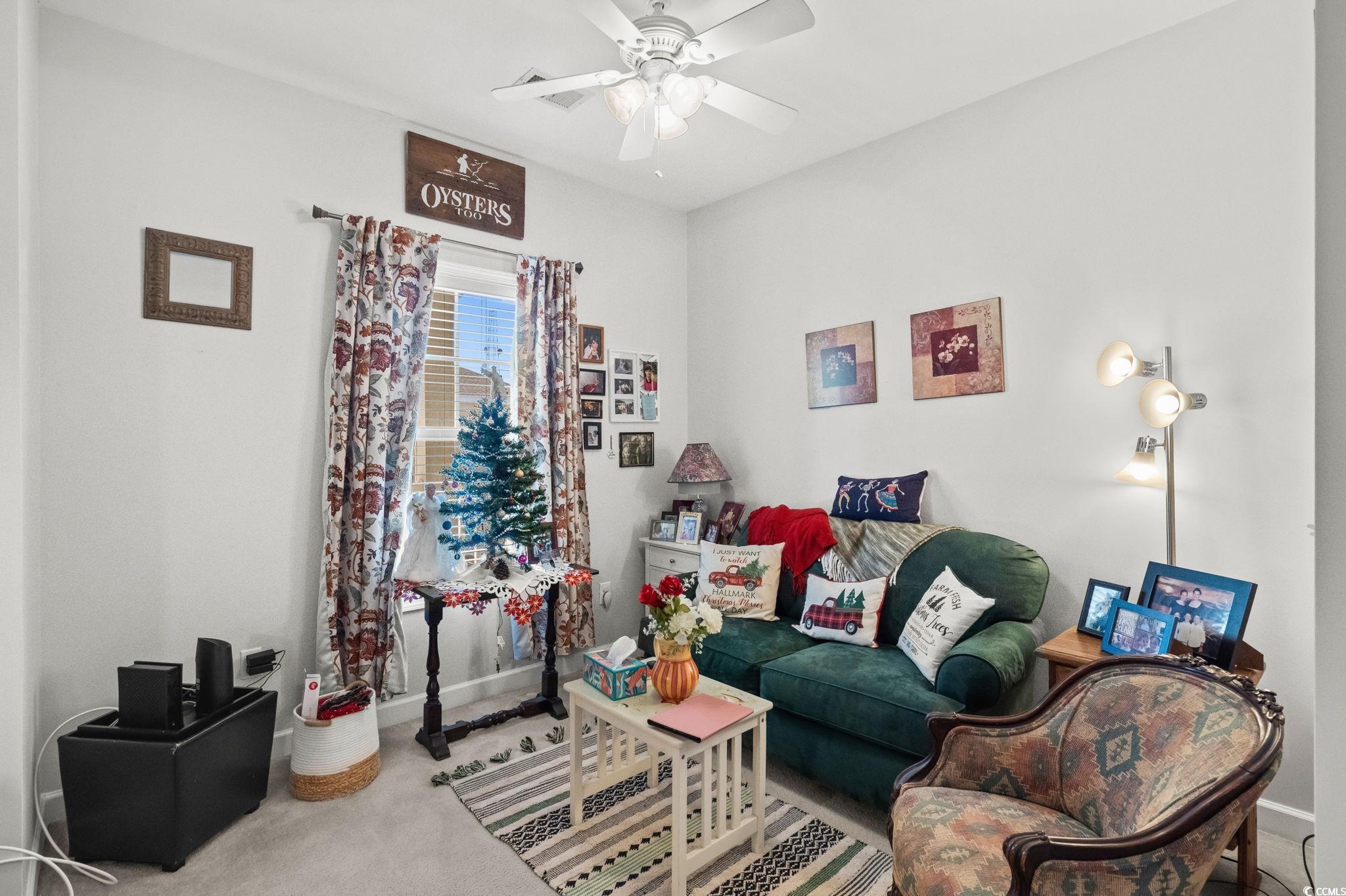336 Kiskadee Loop, Unit 19O Conway, SC 29526 - Photo 18 of 26 Living area with carpet floors and a ceiling fan