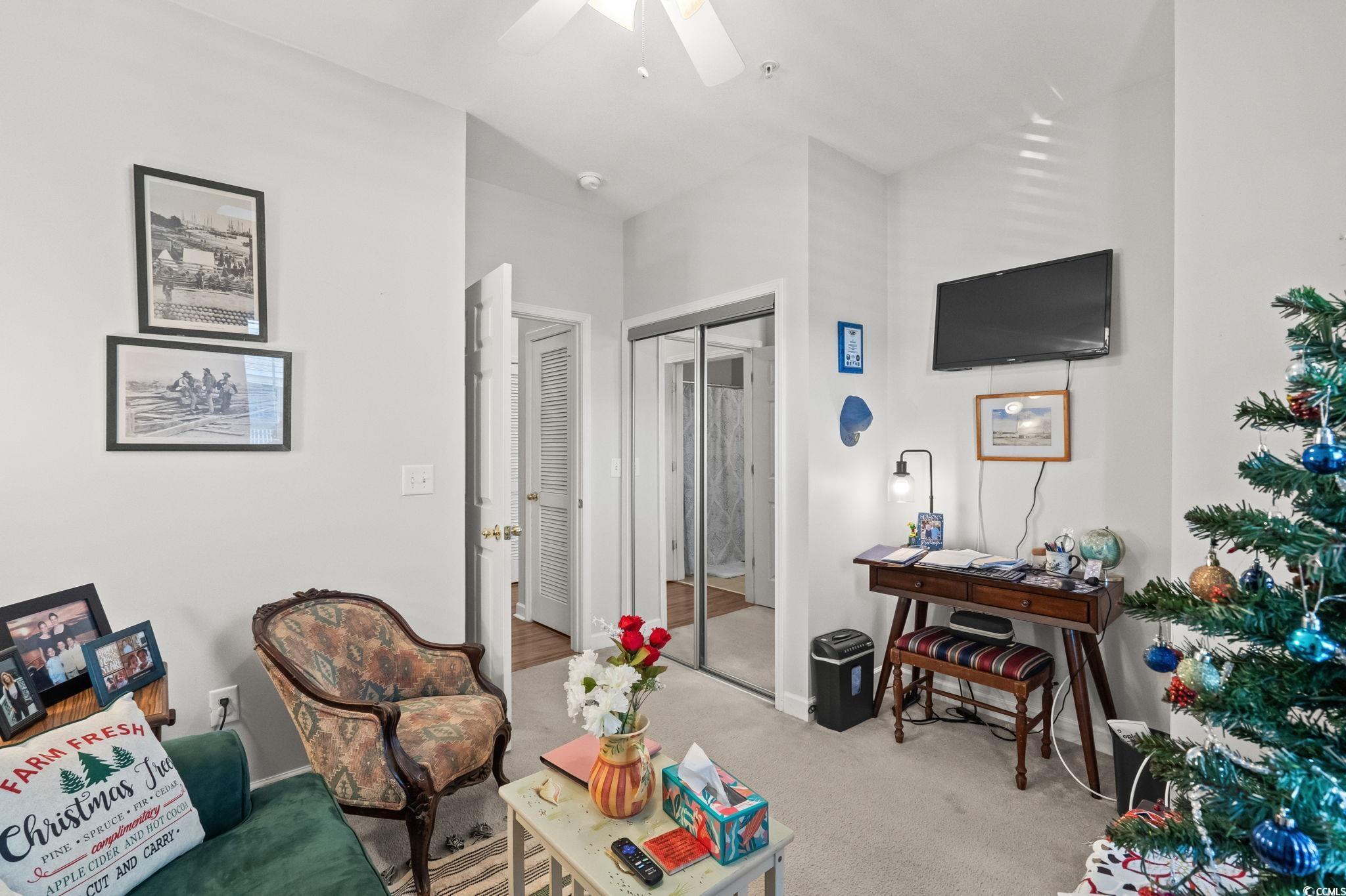 336 Kiskadee Loop, Unit 19O Conway, SC 29526 - Photo 19 of 26 Living area featuring carpet and a ceiling fan
