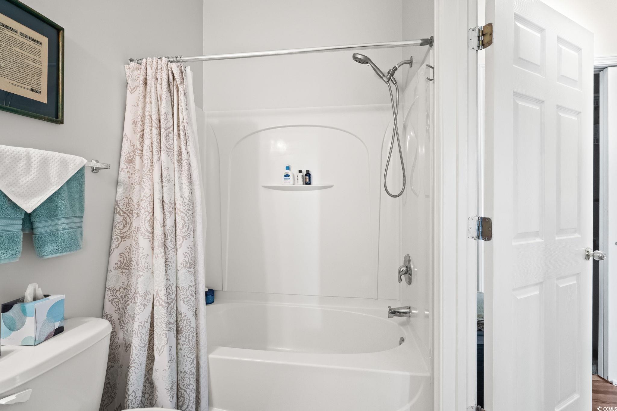 336 Kiskadee Loop, Unit 19O Conway, SC 29526 - Photo 21 of 26 Bathroom featuring shower / bathtub combination with curtain and toilet