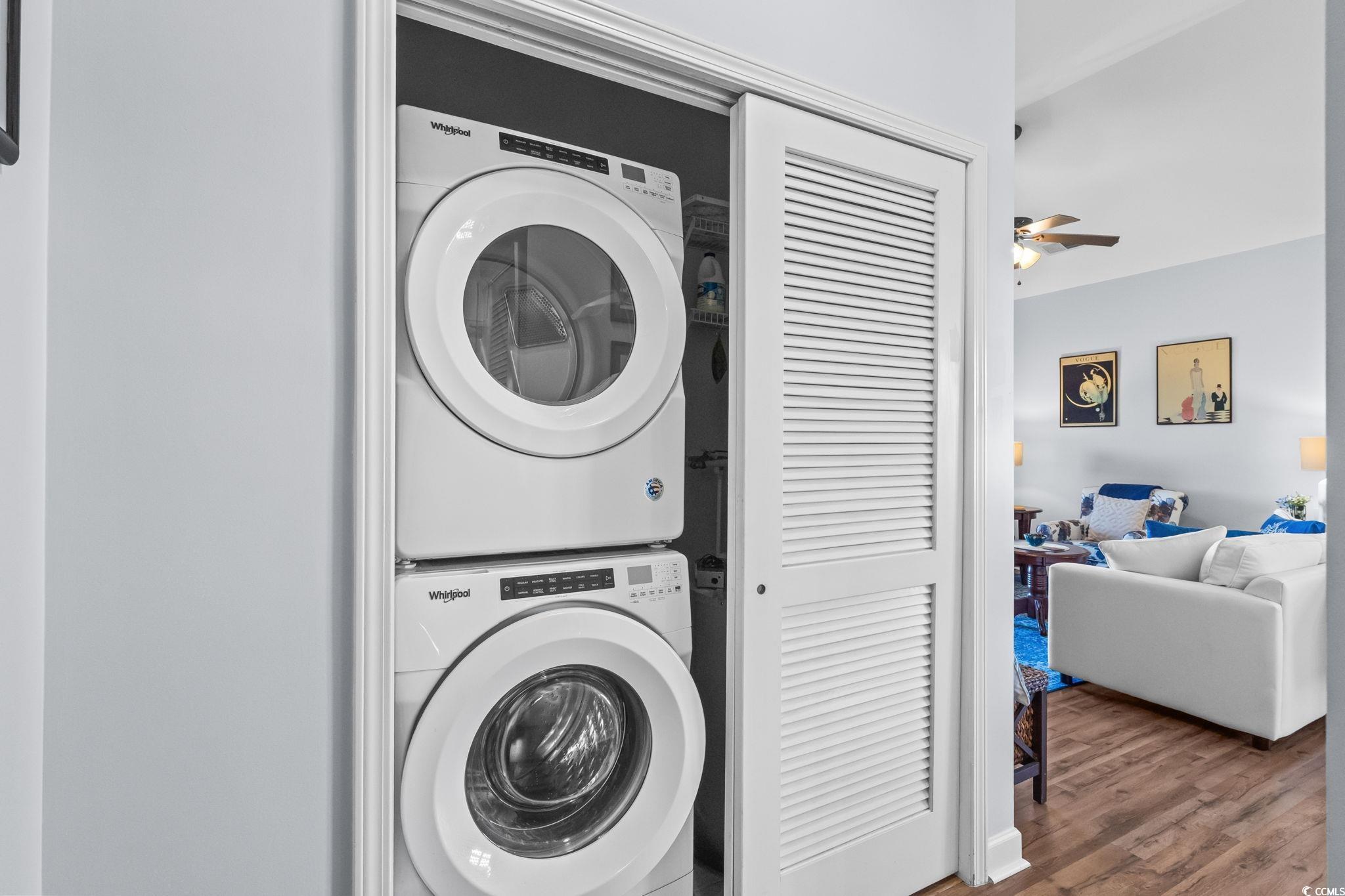 336 Kiskadee Loop, Unit 19O Conway, SC 29526 - Photo 22 of 26 Washroom with wood finished floors, stacked washer and clothes dryer, and a ceiling fan