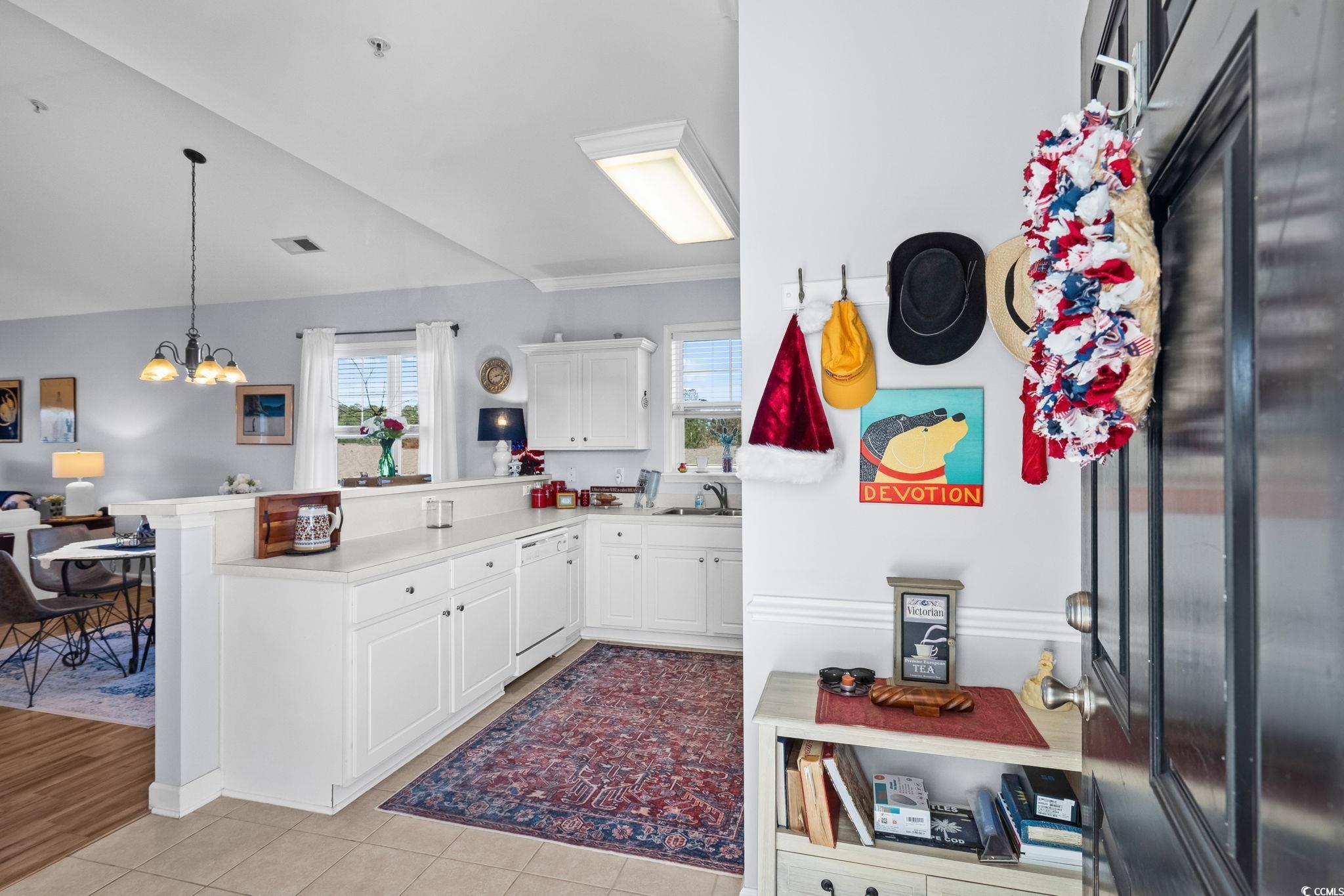 336 Kiskadee Loop, Unit 19O Conway, SC 29526 - Photo 4 of 20 Kitchen featuring white cabinetry, a peninsula, light countertops, dishwasher, and decorative light fixtures