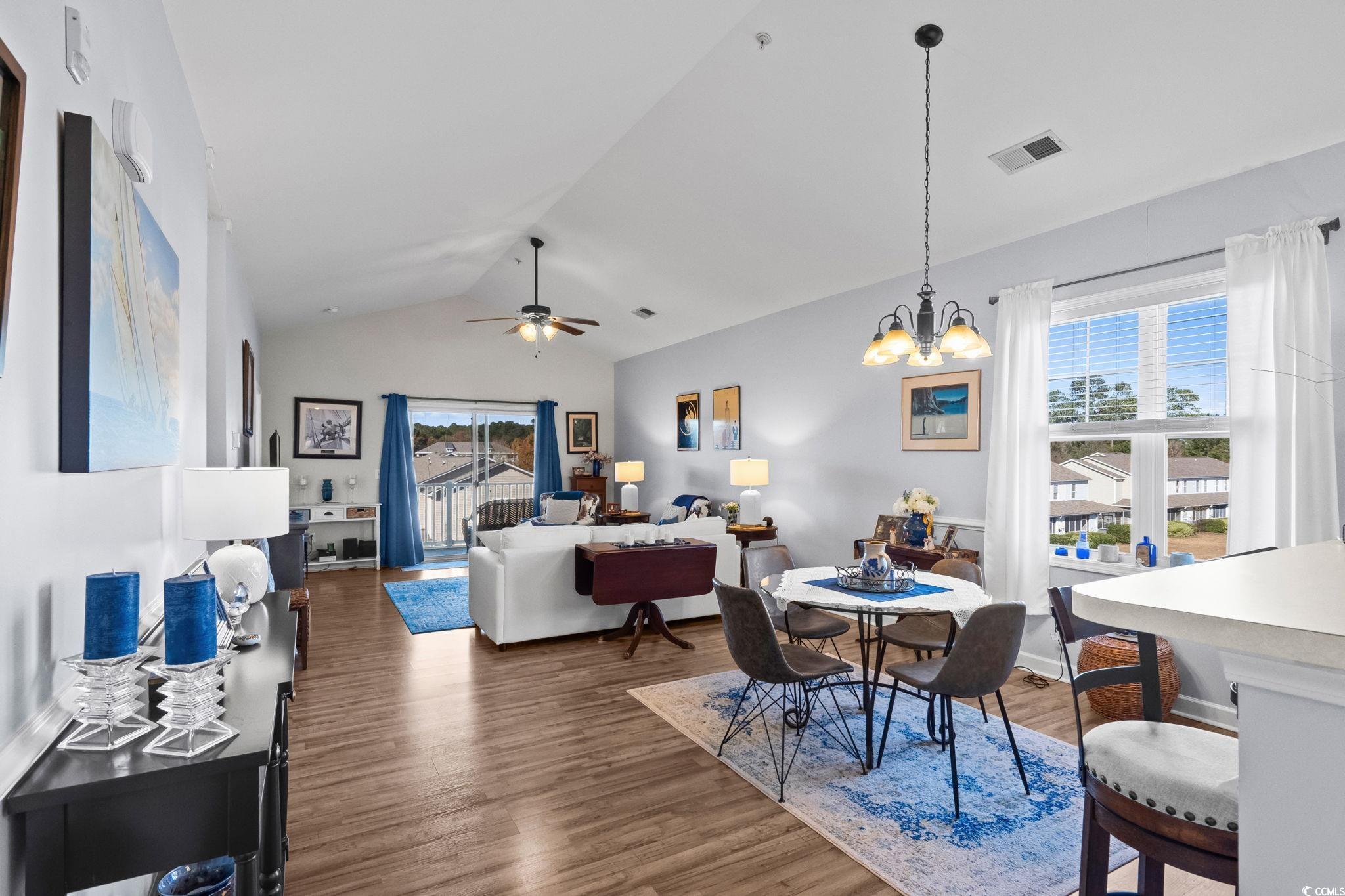 336 Kiskadee Loop, Unit 19O Conway, SC 29526 - Photo 5 of 26 Dining area featuring lofted ceiling, dark wood-style flooring, a chandelier, and a ceiling fan