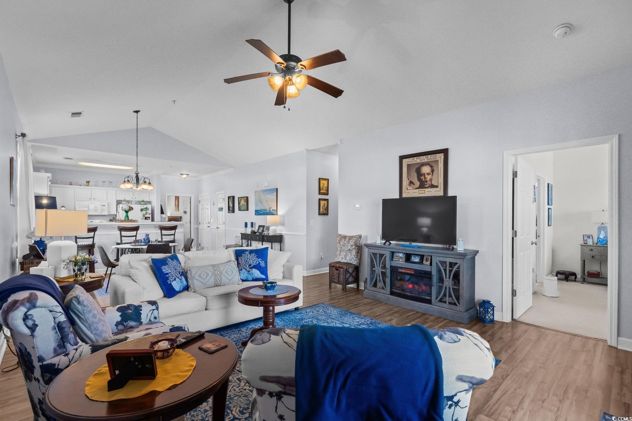 336 Kiskadee Loop, Unit 19O Conway, SC 29526 - Photo 9 of 26 Living room with vaulted ceiling, wood finished floors, a ceiling fan, and a chandelier