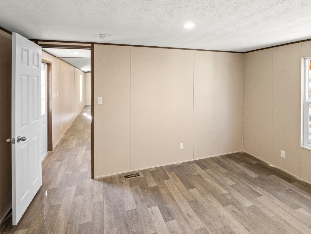 7214 Comstock Cove Lago Vista, TX 78645 - Photo 17 of 20 wooden floor in an empty room with a window