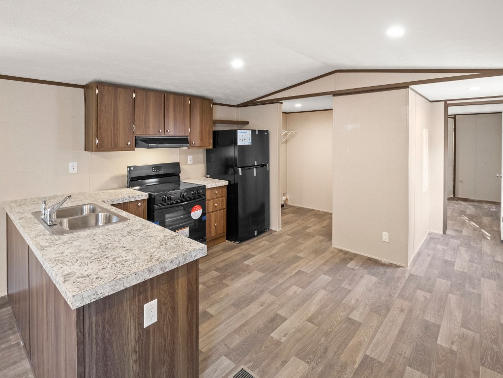 7214 Comstock Cove Lago Vista, TX 78645 - Photo 5 of 20 a kitchen with kitchen island granite countertop a sink stove and refrigerator