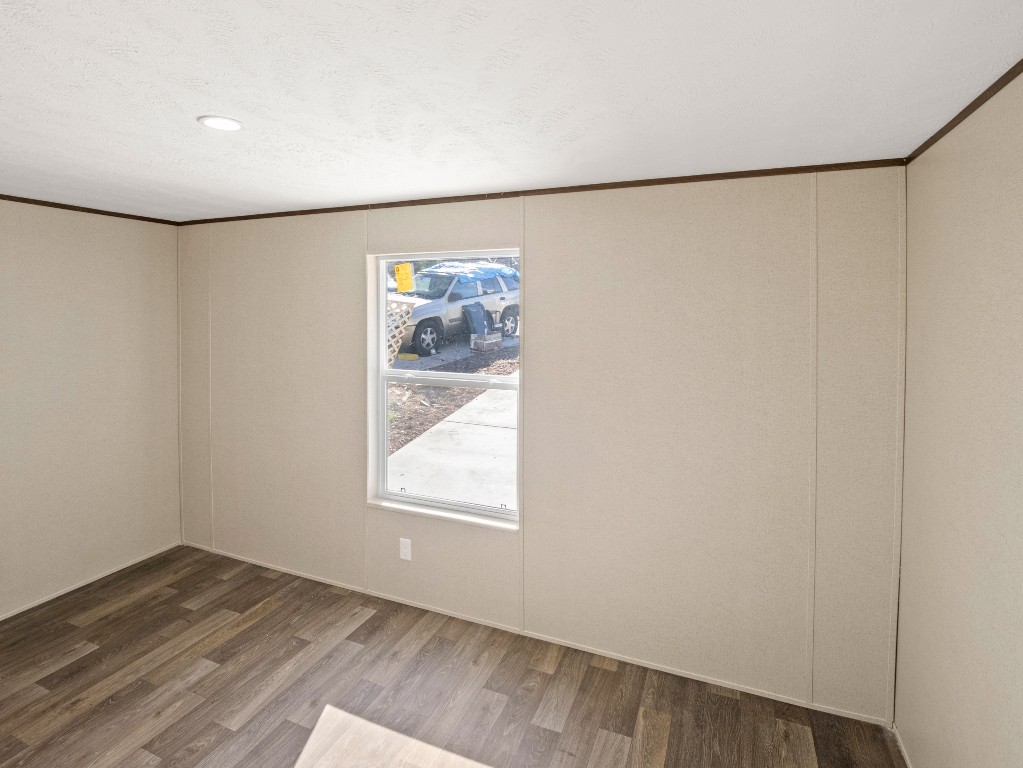 7214 Comstock Cove Lago Vista, TX 78645 - Photo 9 of 20 an empty room with wooden floor and windows