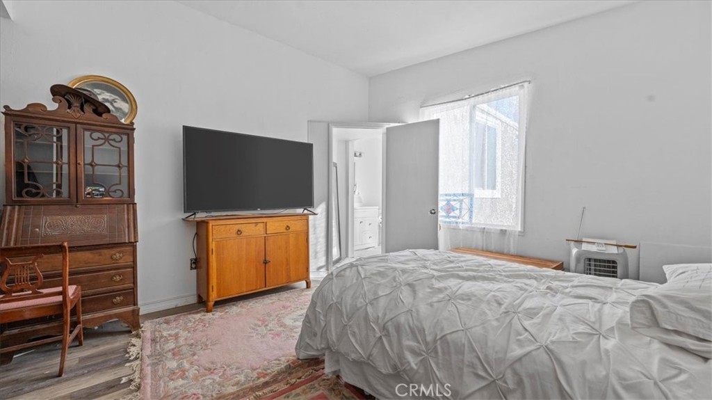 9728 East Avenue R Littlerock, CA 93543 - Photo 13 of 37 a bedroom with a bed and a flat tv screen on dresser