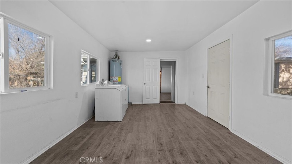 9728 East Avenue R Littlerock, CA 93543 - Photo 19 of 37 a view of a big room with wooden floor and windows