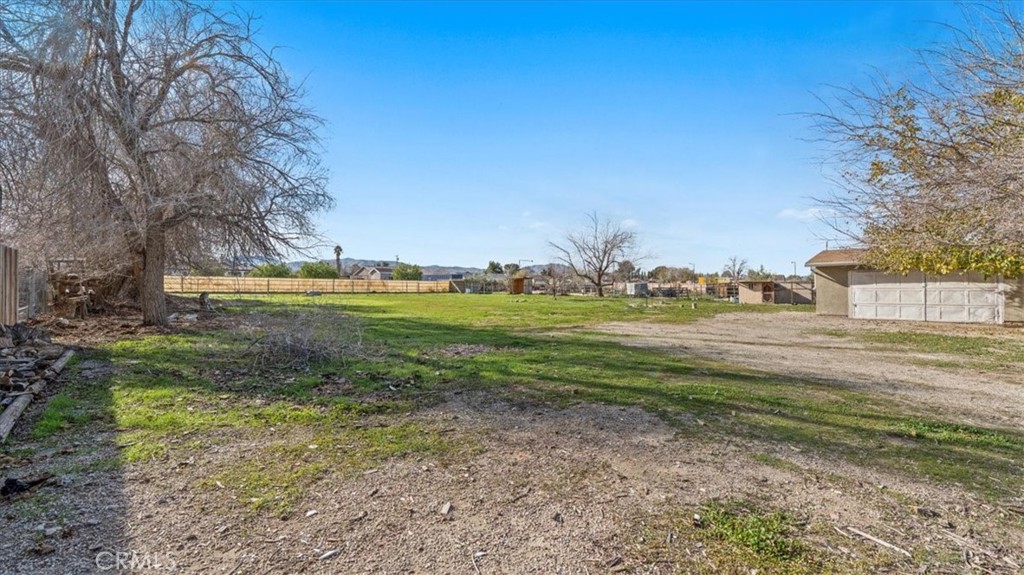 9728 East Avenue R Littlerock, CA 93543 - Photo 23 of 37 a view of a yard with an trees