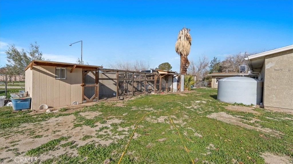 9728 East Avenue R Littlerock, CA 93543 - Photo 28 of 37 a backyard of a house with table and chairs