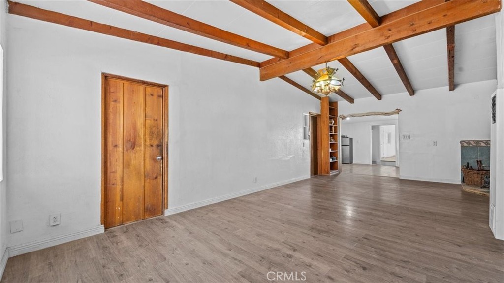 9728 East Avenue R Littlerock, CA 93543 - Photo 5 of 37 a view of a hallway with wooden floor