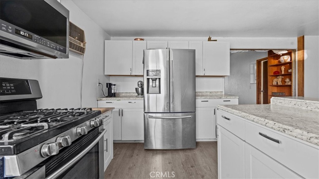 9728 East Avenue R Littlerock, CA 93543 - Photo 10 of 37 a kitchen with stainless steel appliances granite countertop a refrigerator and a stove top oven