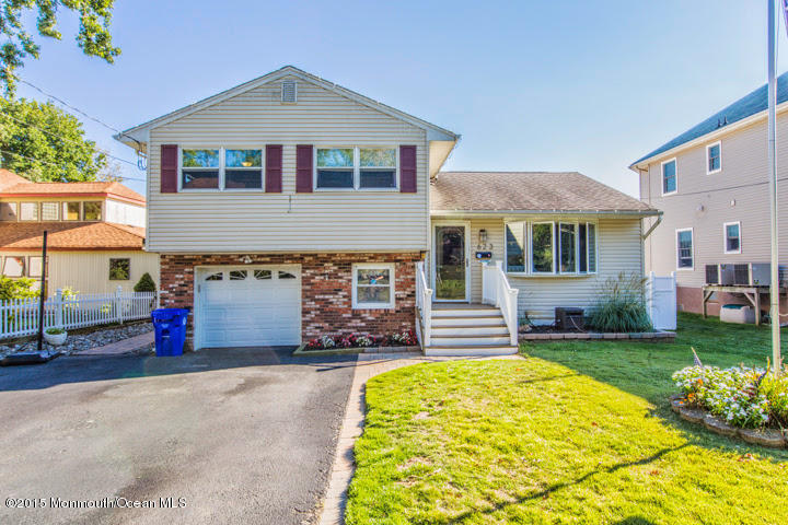 623 Bancroft Road Brick, NJ 08724 - Photo 36 of 91 a front view of a house with a yard and garage