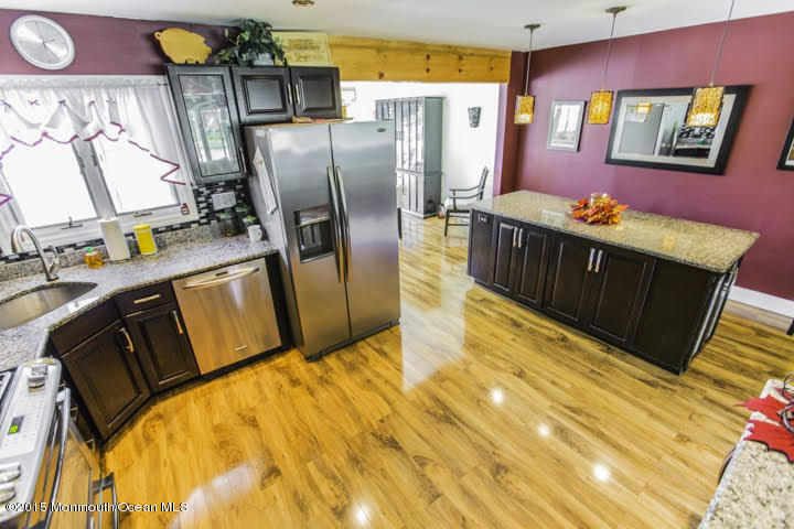 623 Bancroft Road Brick, NJ 08724 - Photo 56 of 91 a kitchen with stainless steel appliances granite countertop a refrigerator a stove and a wooden cabinets