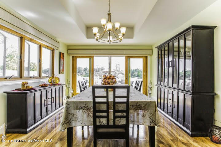 623 Bancroft Road Brick, NJ 08724 - Photo 60 of 91 a view of a dining room with furniture large windows wooden floor and chandelier