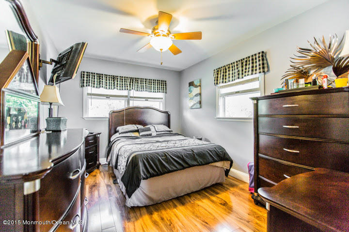623 Bancroft Road Brick, NJ 08724 - Photo 77 of 91 a bedroom with a bed and a chandelier