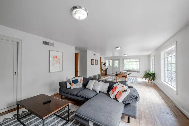 a living room with furniture or couch and a wooden floor