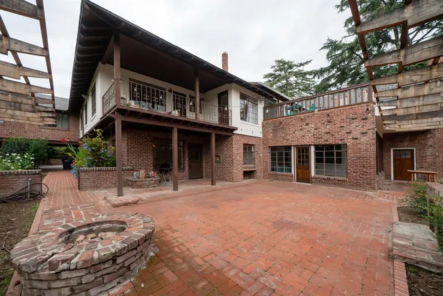 a front view of a house with sitting area