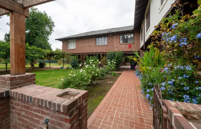 a pathway of a house with a yard