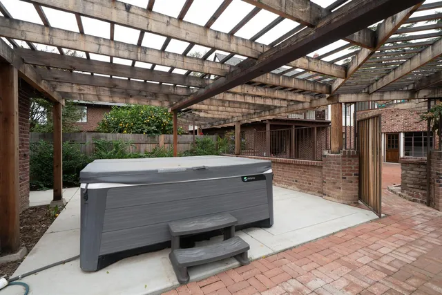 a view of a patio with table and chairs with wooden floor and fence
