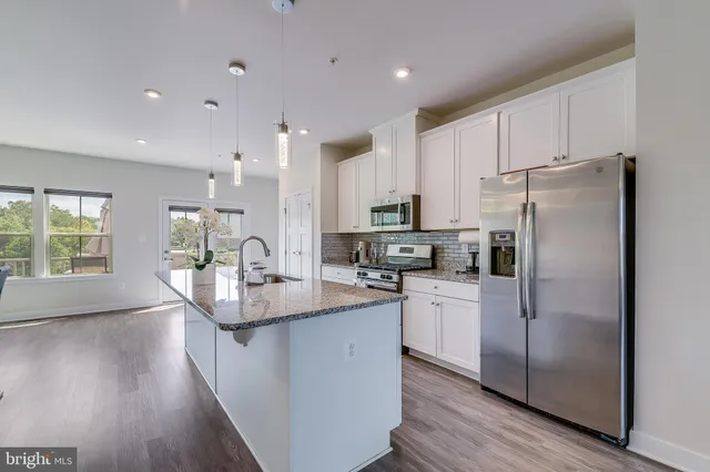a kitchen with refrigerator and cabinets