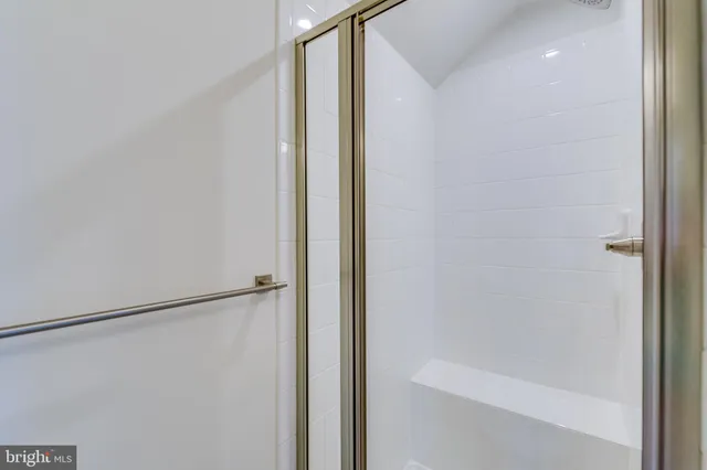 a bathroom with a glass shower door
