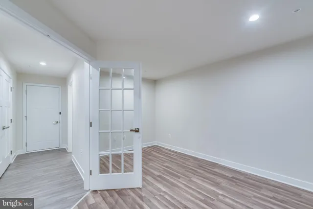 a view of empty room with wooden floor