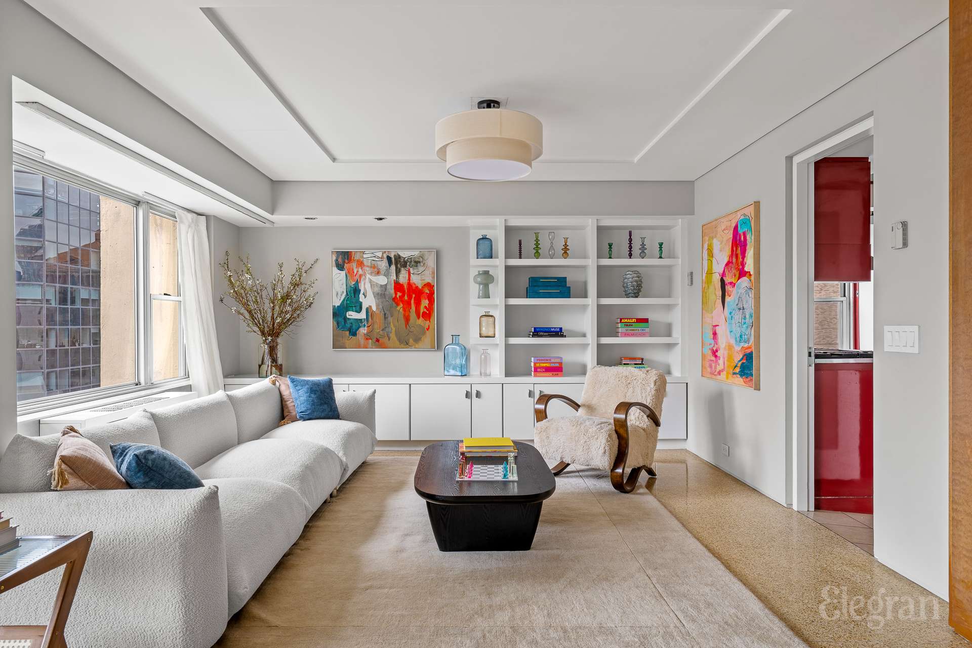 118 East 60th Street, Unit 33/32 DUPLEX Manhattan, NY 10022 - Photo 13 of 23 a living room with furniture and a book shelf