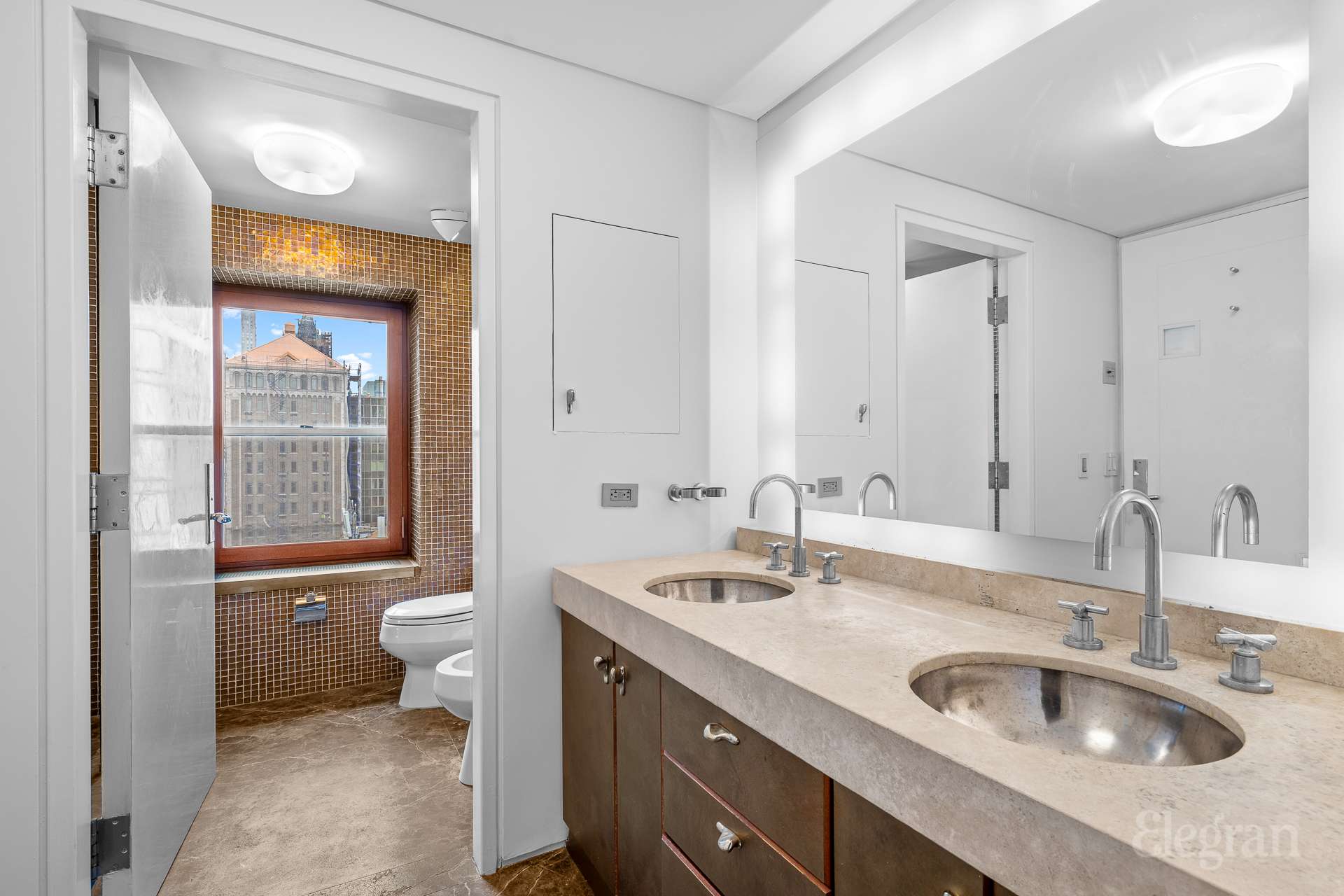 118 East 60th Street, Unit 33/32 DUPLEX Manhattan, NY 10022 - Photo 16 of 23 a bathroom with a sink and a toilet