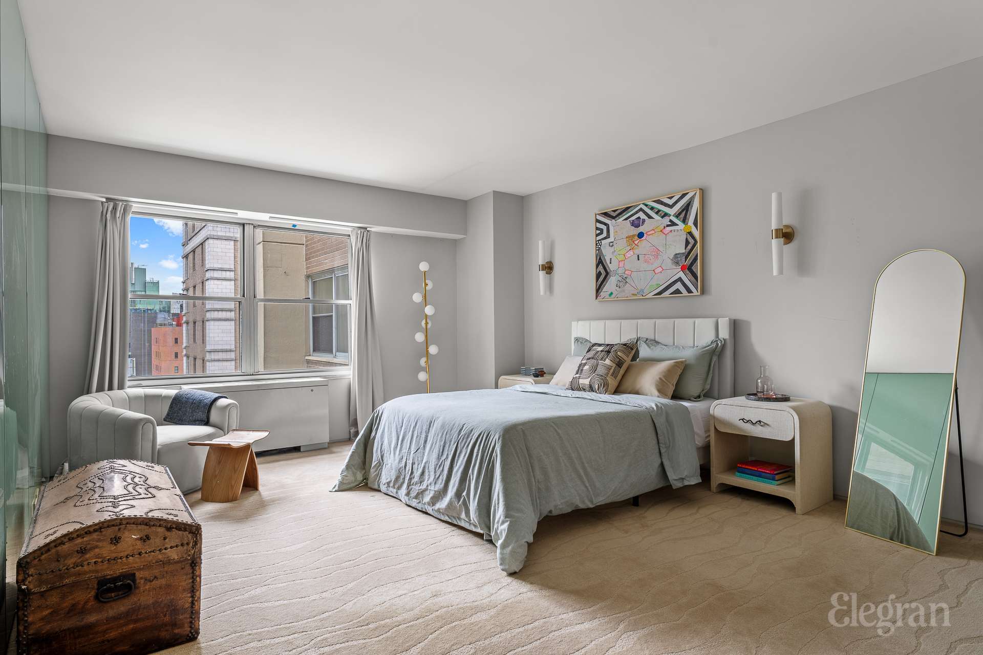 118 East 60th Street, Unit 33/32 DUPLEX Manhattan, NY 10022 - Photo 20 of 23 a spacious bedroom with a bed and a couch