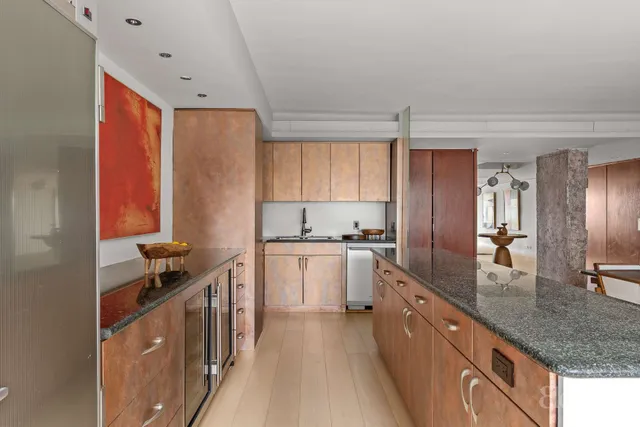 a kitchen with stainless steel appliances granite countertop a sink stove and cabinets