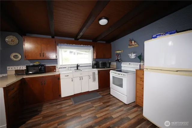 a kitchen with white cabinets and white appliances