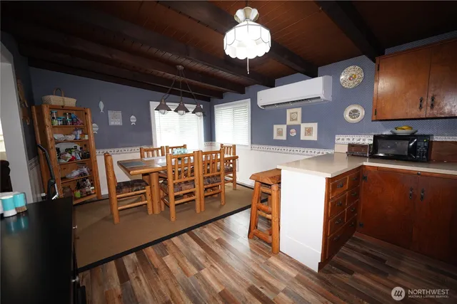 a view of a dining room with furniture a chandelier and wooden floor