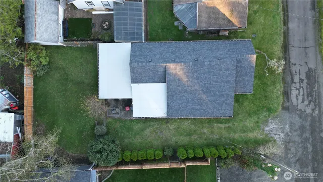 an aerial view of a house with a yard